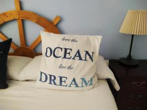 
a bed with a pillow and a note on it at Spanish Galleon Lodge in Cádiz
