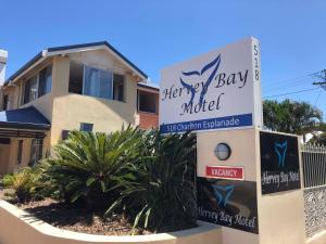 a sign for a therapy bay motel in front of a house at Hervey Bay Motel in Hervey Bay