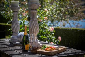 a table with a bottle of wine and a plate of food at 139 On Peninsula - The ideal retreat 2 Bedroom Apartment in Queenstown