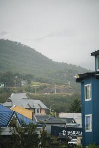 a group of houses with a mountain in the background at Departamento Ideal in Ushuaia
