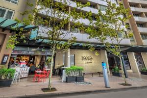 a building with a cafe in front of it at Mantra Chatswood in Sydney