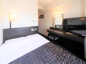 a hotel room with a large bed and a flat screen tv at APA Hotel Tennoji-Ekimae in Osaka