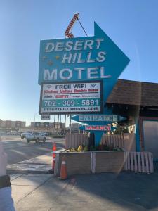 a sign for a desert hills motel on a street at Desert Hills Motel in Las Vegas