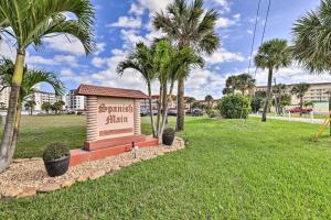 a sign for a resort in a park with palm trees at Central Cocoa Beach Condo with View, Steps to Beach! in Cocoa Beach