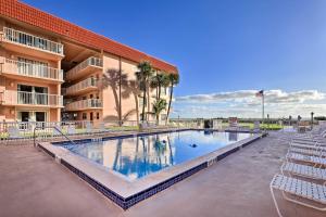 a large swimming pool in front of a hotel at Central Cocoa Beach Condo with View, Steps to Beach! in Cocoa Beach