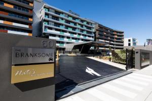 a large building with a sign on the side of it at The Branksome Hotel & Residences in Sydney