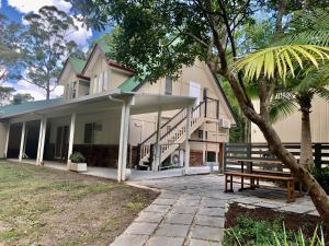 a house with a bench in front of it at Woodford Gardens in Woodford