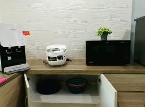 a kitchen counter with a coffee maker and a toaster at Leisure homestay@Kota Kinabalu in Kota Kinabalu