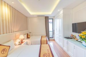 Postel nebo postele na pokoji v ubytování Hanoi HM Boutique Hotel