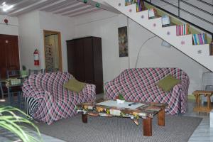 two chairs and a coffee table in a living room at Yoo C Apartment in Dumaguete