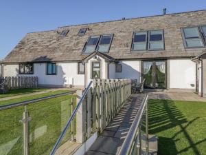 a house with a fence in front of it at Primrose Cottage in Ulverston