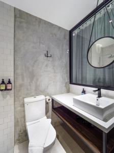 a bathroom with a white toilet and a sink at Tune Hotel KLIA-KLIA2, Airport Transit Hotel in Sepang