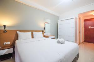Ένα ή περισσότερα κρεβάτια σε δωμάτιο στο Warm and Relax Studio at Signature Park Grande Apartment By Travelio +10 φωτογραφίες