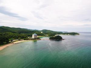 an island in the middle of the water with a beach at Kumgangsan Condo Sokcho in Goseong