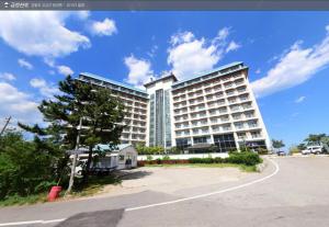 a large building with a road in front of it at Kumgangsan Condo Sokcho in Goseong