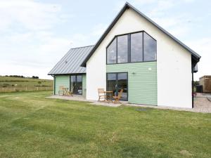 a house with a green and white facade at Chance Inn Lodge in Balmedie