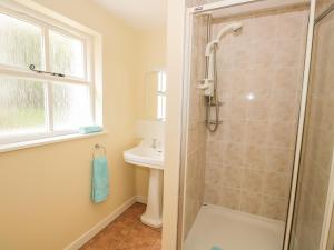 a bathroom with a shower and a sink at Town End Farmhouse in Newby Bridge +21 photos