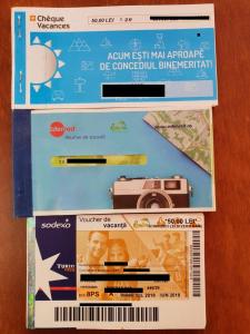 a package with a camera and a pen on a table at C&Y Zev Apartments in Mamaia