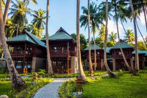 a resort with palm trees in front of it at Sea Shell Resort & Spa, Havelock in Havelock Island