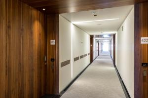 a corridor of a building with wooden walls and a long hallway at Parador de Cádiz in Cádiz