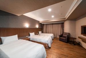 Krevet ili kreveti u jedinici u objektu Fish Hotel-Pingtung