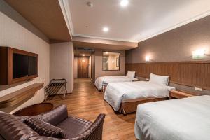 Krevet ili kreveti u jedinici u objektu Fish Hotel-Pingtung