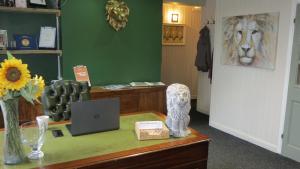 a office with a desk with a laptop and a lion on it at The Lion Waddesdon in Waddesdon