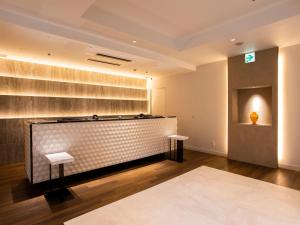Postel nebo postele na pokoji v ubytování HOTEL MYSTAYS Aomori Station