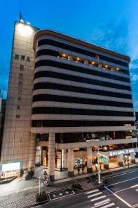 a large building with a street in front of it at Fish Hotel-Pingtung in Pingtung City