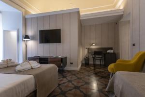 Televízia a/alebo spoločenská miestnosť v ubytovaní B&B Palazzo Perrotta