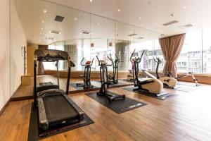 a gym with a bunch of treadmills and exercise bikes at Fish Hotel-Pingtung in Pingtung City