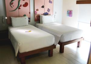 two beds sitting next to each other in a room at MaxOneHotels.com at Sabang in Jakarta