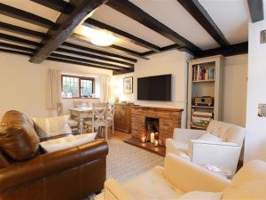 a living room with a couch and a fireplace at One Masons Court in Stratford-upon-Avon