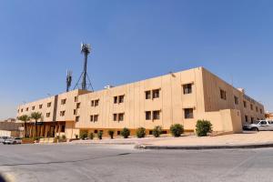 Capital O 419 Al Safeer Hotel في الرياض: مبنى كبير عليه هوائي