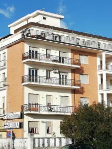 a tall building with balconies on the side of it at B&B Attico Mare in San Benedetto del Tronto