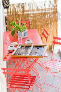 a red table with a tray on top of it at Sea Breeze Vibes in Nea Peramos