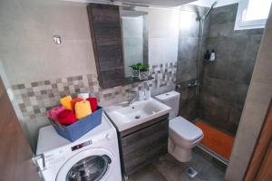 a bathroom with a washing machine and a sink at Sea Breeze Vibes in Nea Peramos