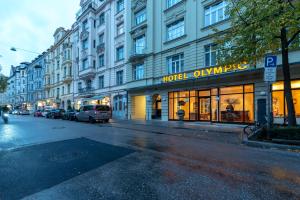 een stadsstraat met een hotel aan de zijkant van een gebouw bij Hotel Olympic in München