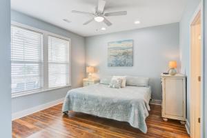 a bedroom with a bed and a ceiling fan at LaiDDback in Folly Beach