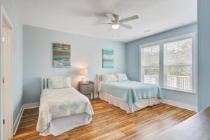 a bedroom with two beds and a ceiling fan at LaiDDback in Folly Beach