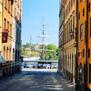 an empty street with a tall ship in the distance at Gamla Stan Apartments in Stockholm