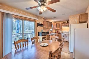 a kitchen with a wooden table and a refrigerator at Walk to Pool and Lake Albrightsville Vacation Home! in Albrightsville