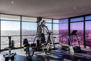 a gym with a view of the city at Aquarius Luxury Suites in Bloubergstrand