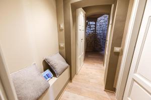 a hallway with a hallway leading into a room with a door at Bolgheri Wine Suite in Bolgheri