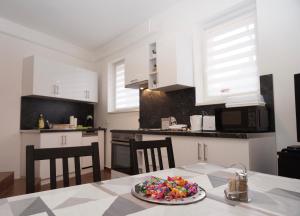a kitchen with a table with a plate of food on it at Toscana 2 Debrecen in Debrecen