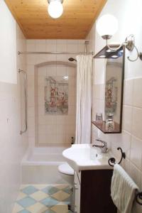 a bathroom with a sink and a tub and a toilet at Ferienpension Posthof in Waldmünchen +27 photos