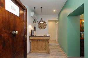 a hallway with aoyer with a desk and a door at Roma Suite Monti in Rome +34 photos