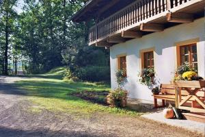 a porch of a house with a bench and flowers at Ferienpension Posthof in Waldmünchen