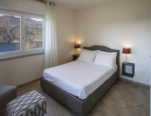a bedroom with a large bed with a window at Calathea B&B in Pettenasco +25 photos