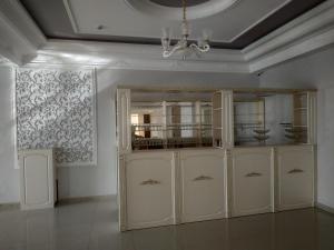 a room with white cabinets and a chandelier at Турист in Taraz